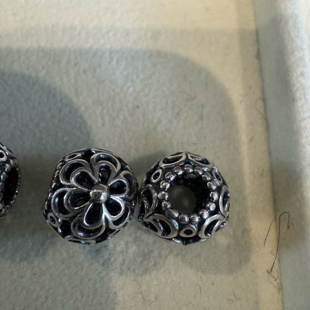 Two floral and abstract Pandora beads